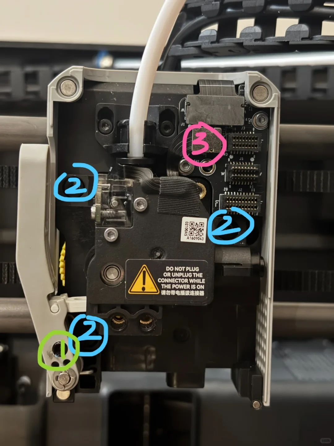 Close-up view of a disassembled 3D printer toolhead assembly with exposed circuit board, connectors, and extruder mechanism, marked with colorful circled numbers 1, 2, and 3.