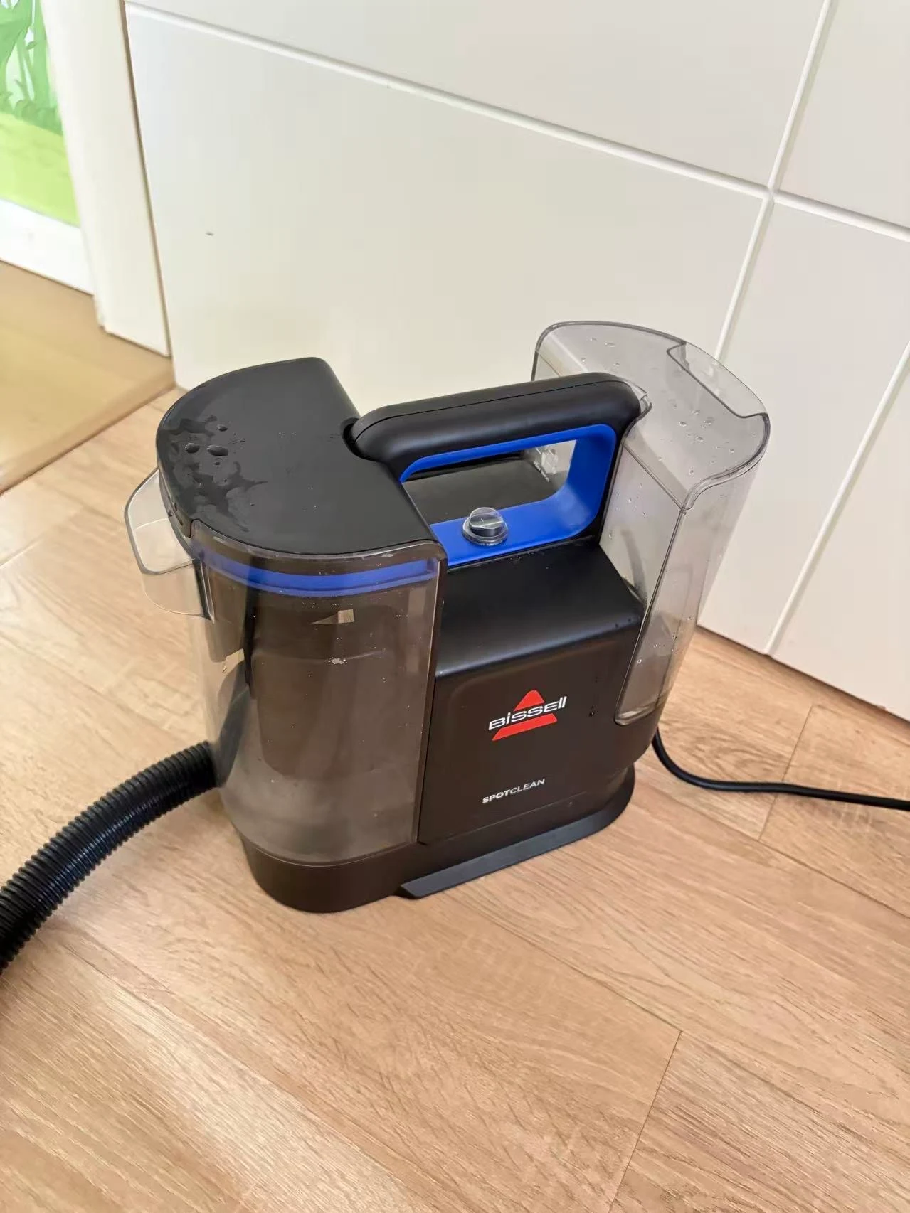 The compact SpotClean with its carry handle and separate tanks.