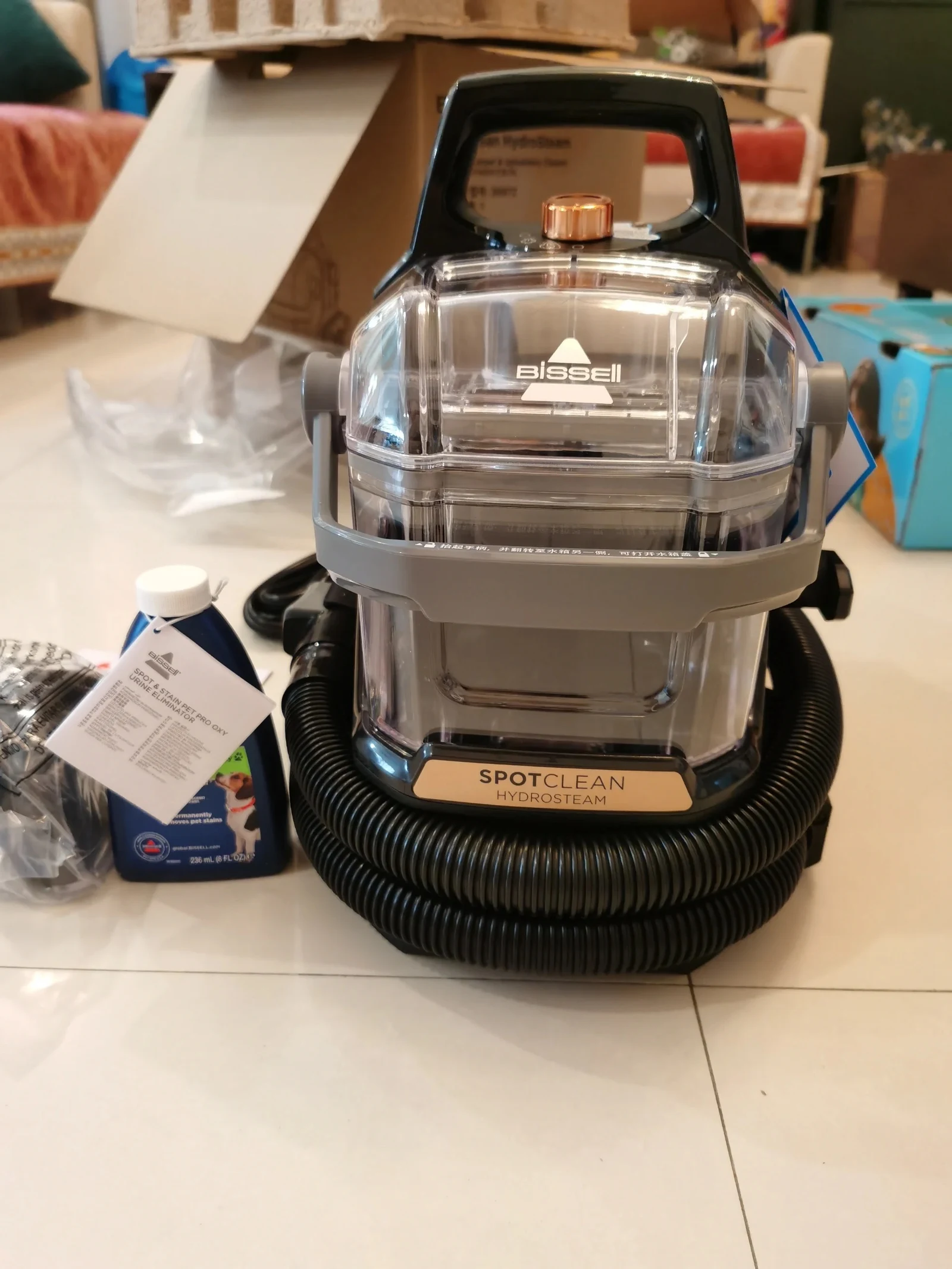 The SpotClean HydroSteam unpacked with cleaning formula.