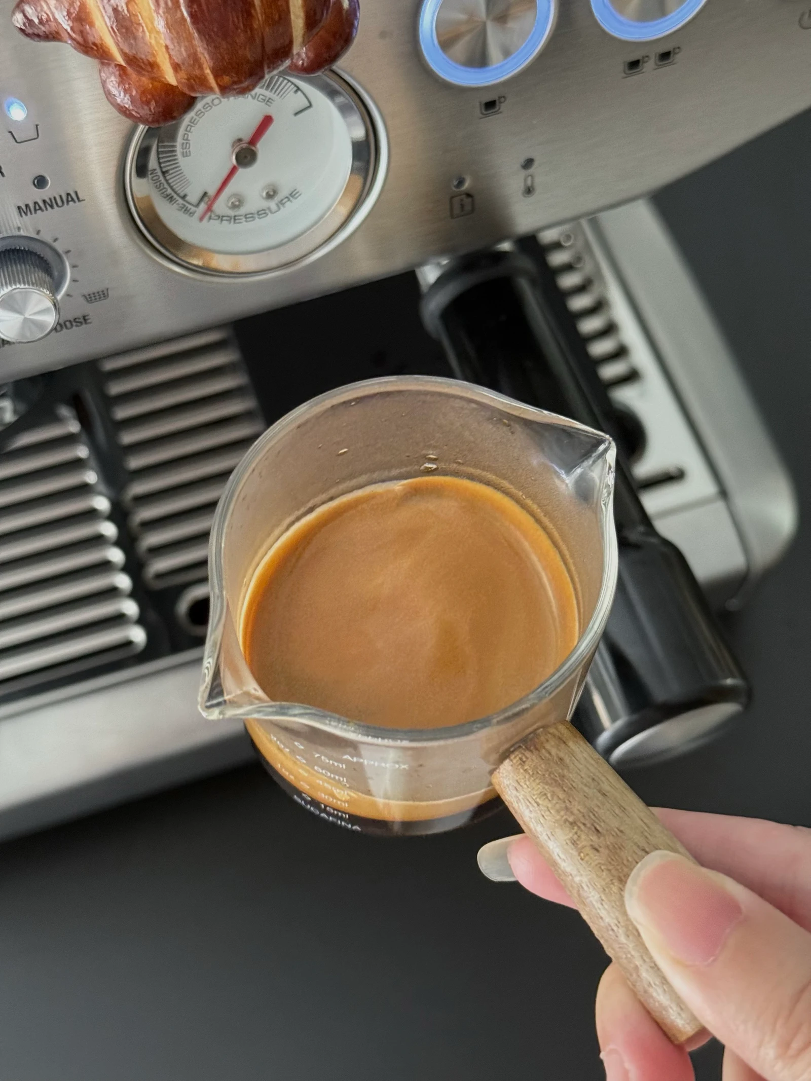 The owner holding a jug of espresso.