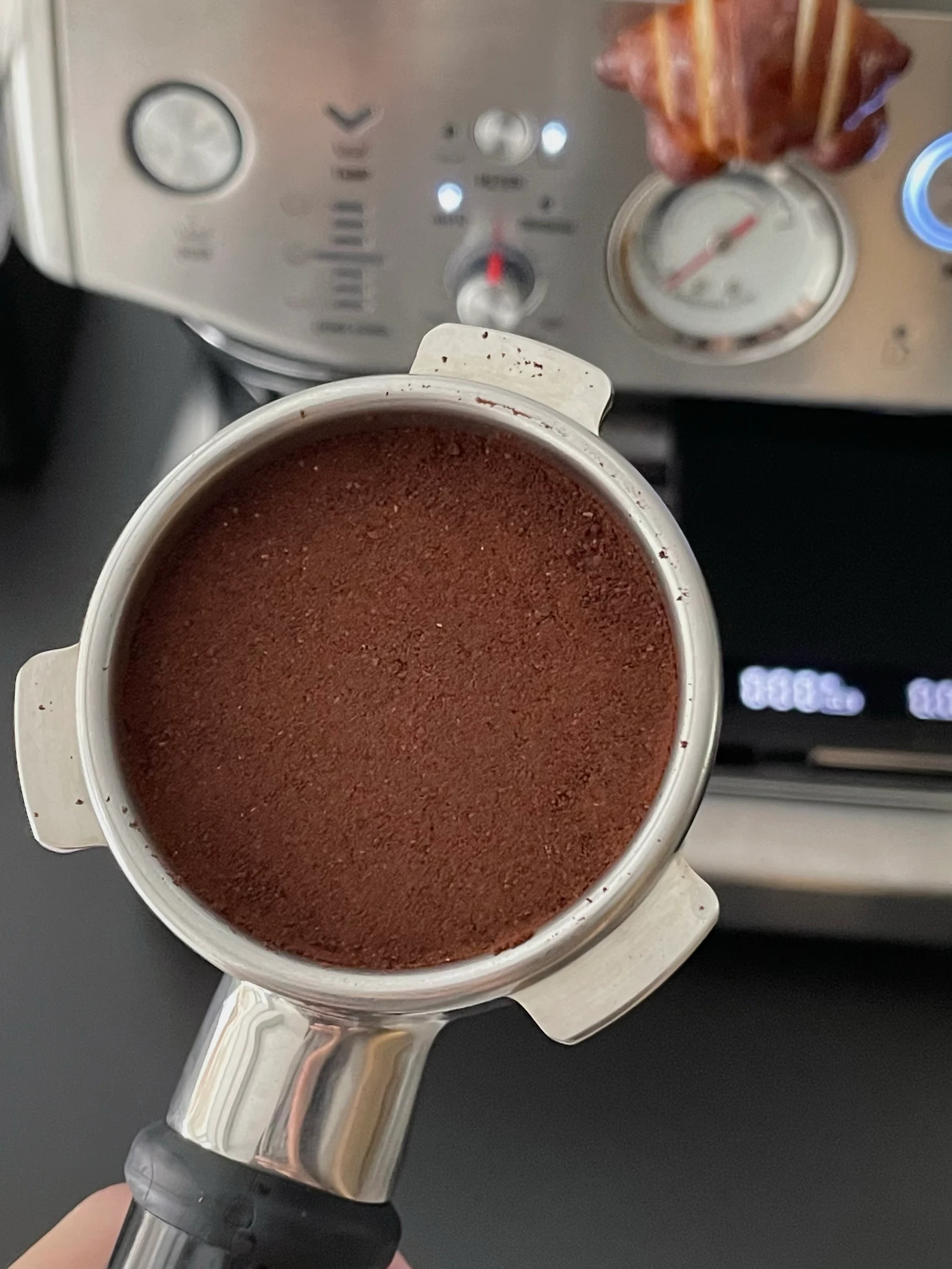 The tamped coffee puck in the portafilter.