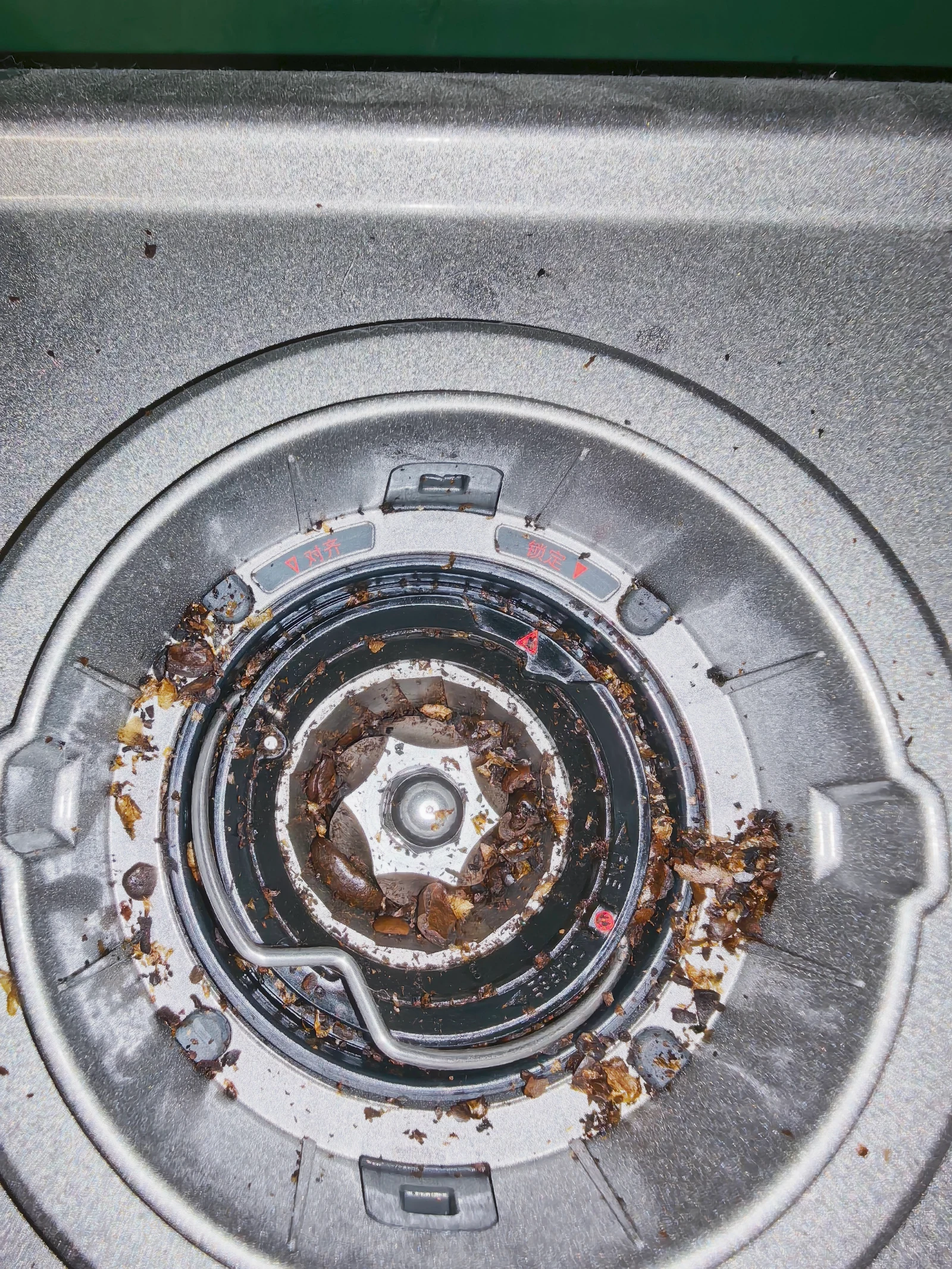 Accumulated grounds inside the grinder chamber.