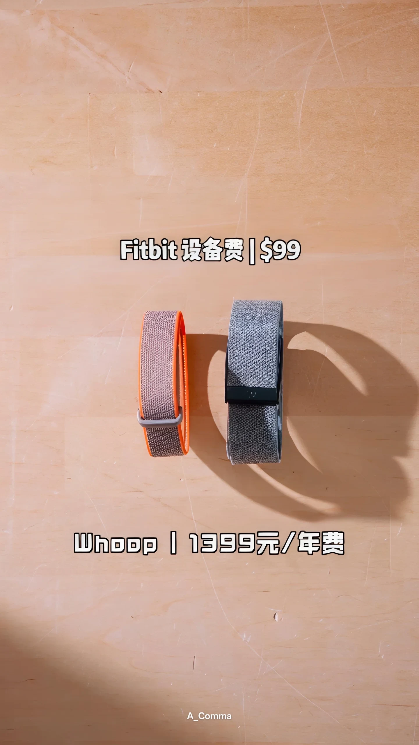 A comparison of two fitness bands on a wooden tabletop: a slim orange-and-gray Fitbit band on the left and a wider gray Whoop band on the right, with pricing labels indicating Fitbit's device fee and Whoop's annual subscription cost.