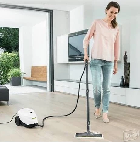 A staged manufacturer lifestyle photograph included in the source article, showing a person using a Kärcher steam cleaner in a living room.