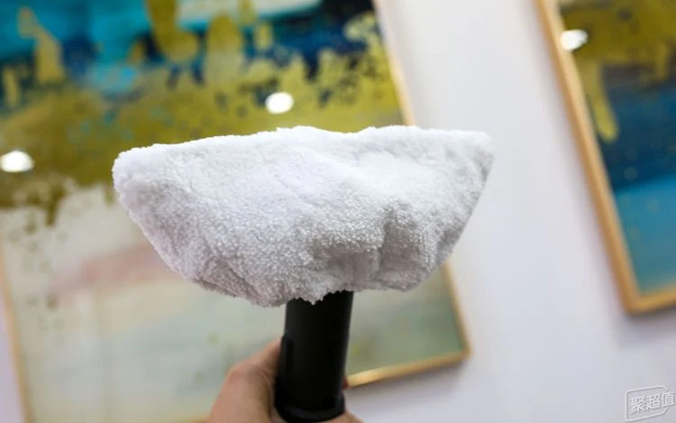 Handheld nozzle attachment of the Kärcher SC3 steam cleaner fitted with a white microfiber towel cover.