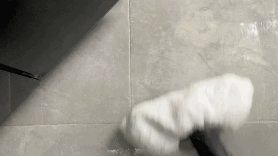 Top-down view of the Kärcher SC3 steam mop head gliding across a tiled floor.