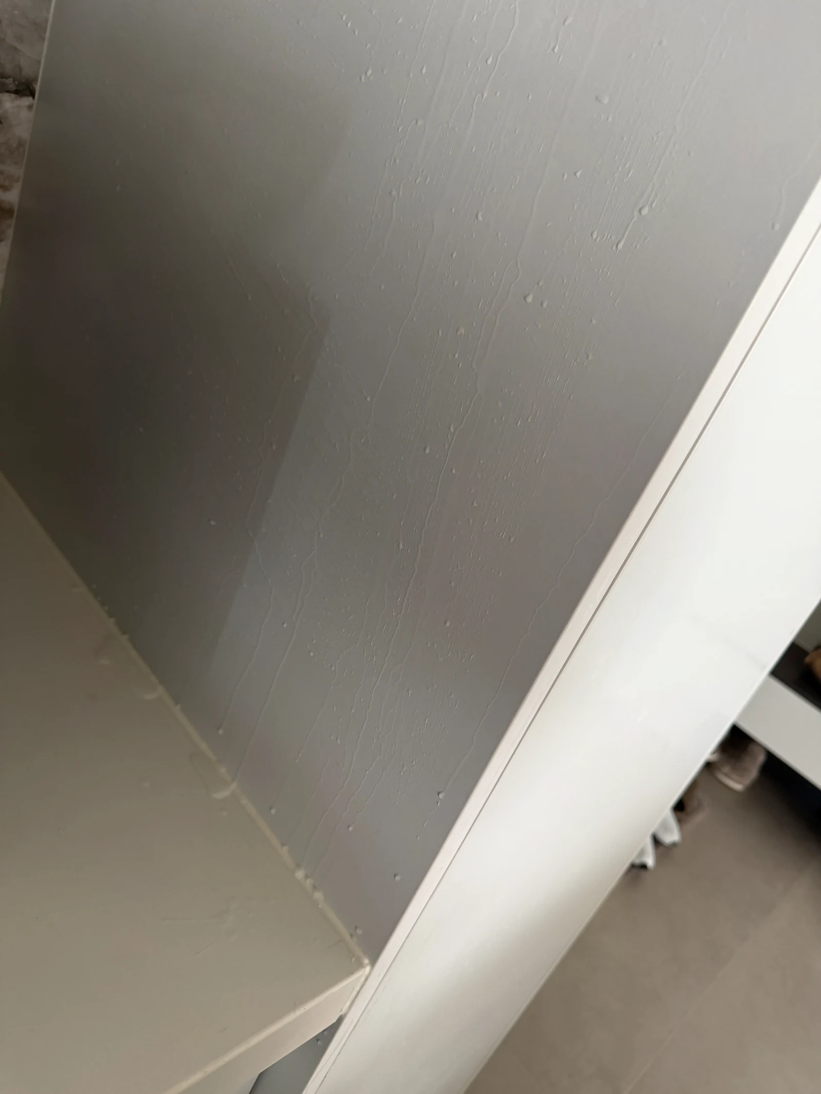 Droplets on a cabinet surface during cleaning.