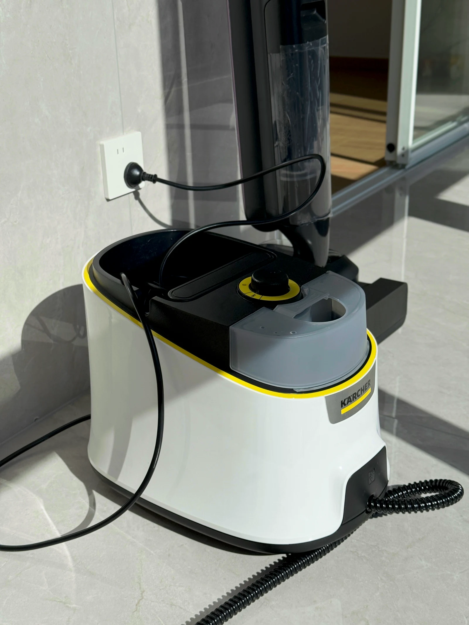 The owner’s Kärcher canister steam cleaner beside the window.