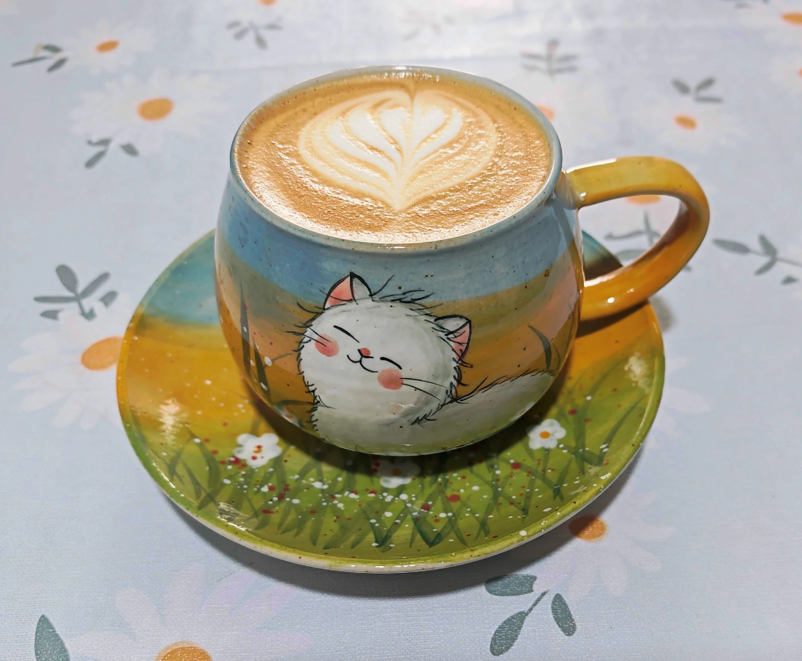 Latte art in a decorated cup.