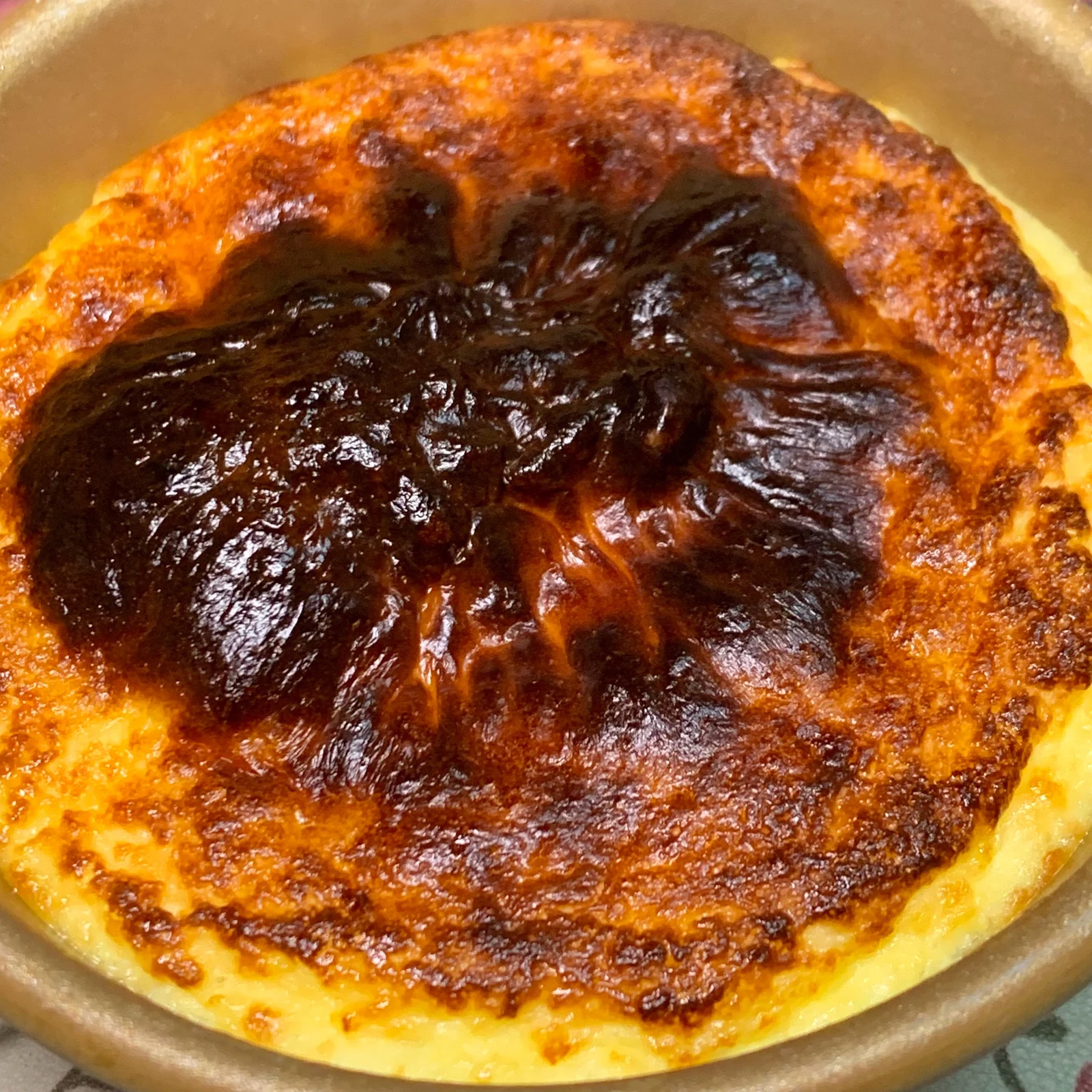 A Basque-style cheesecake with a deeply browned top.