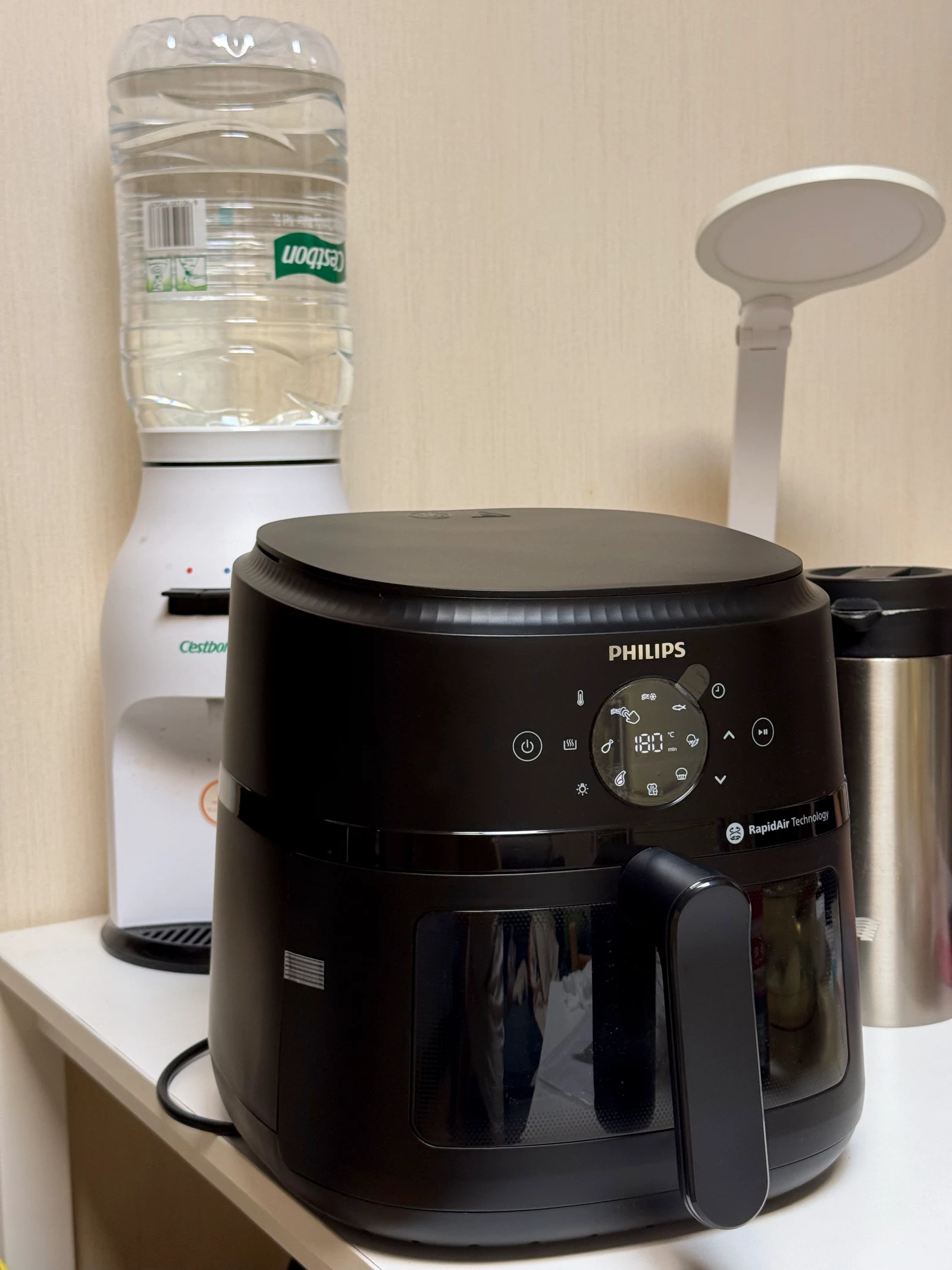 The NA230 beside a water dispenser and lamp.