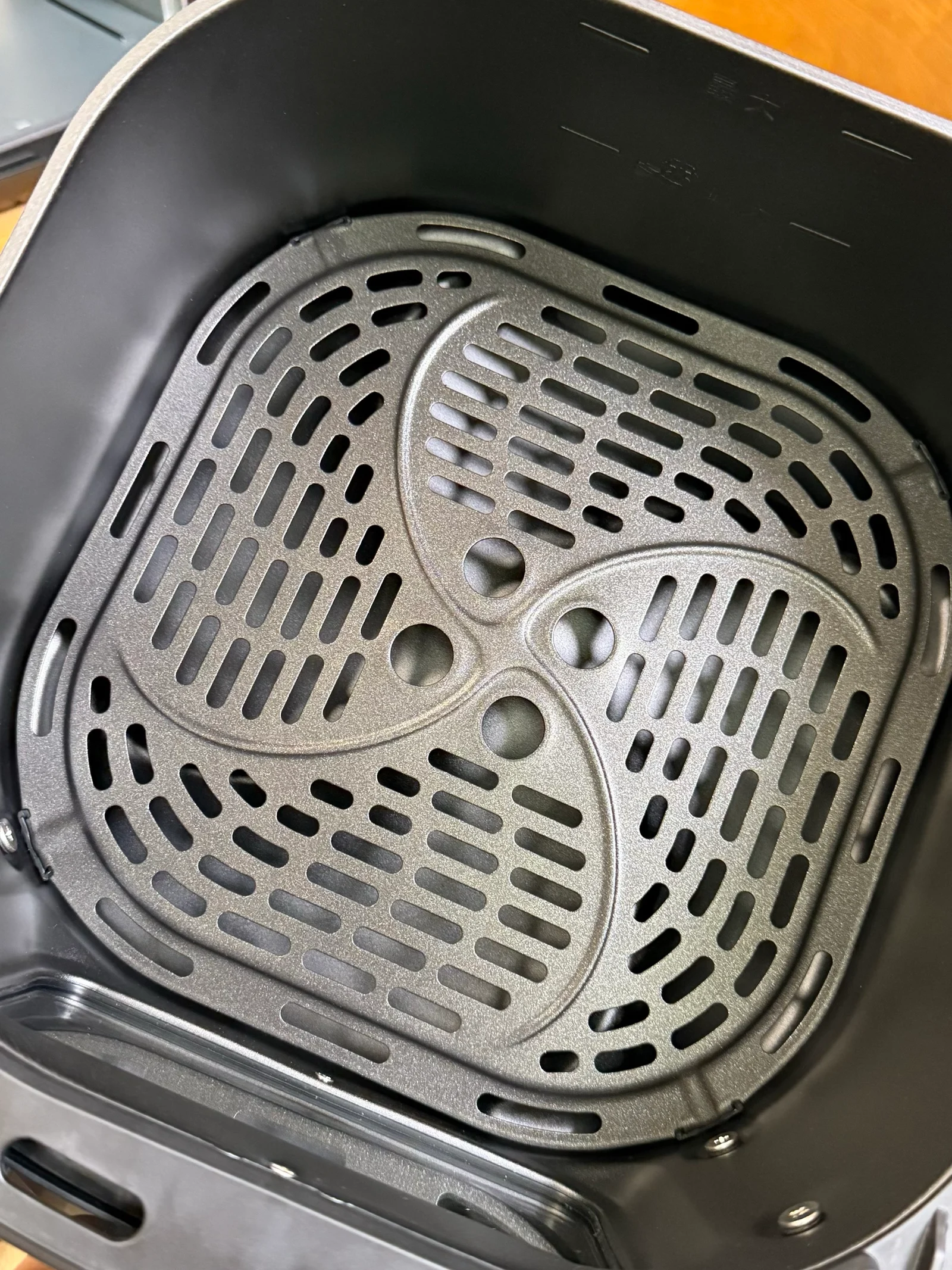 The removable perforated StarPlate inside the air-fryer basket.