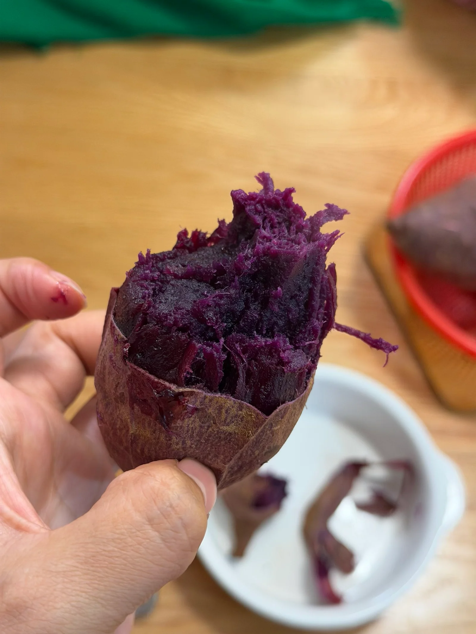 A cooked purple sweet potato opened to reveal its flesh.
