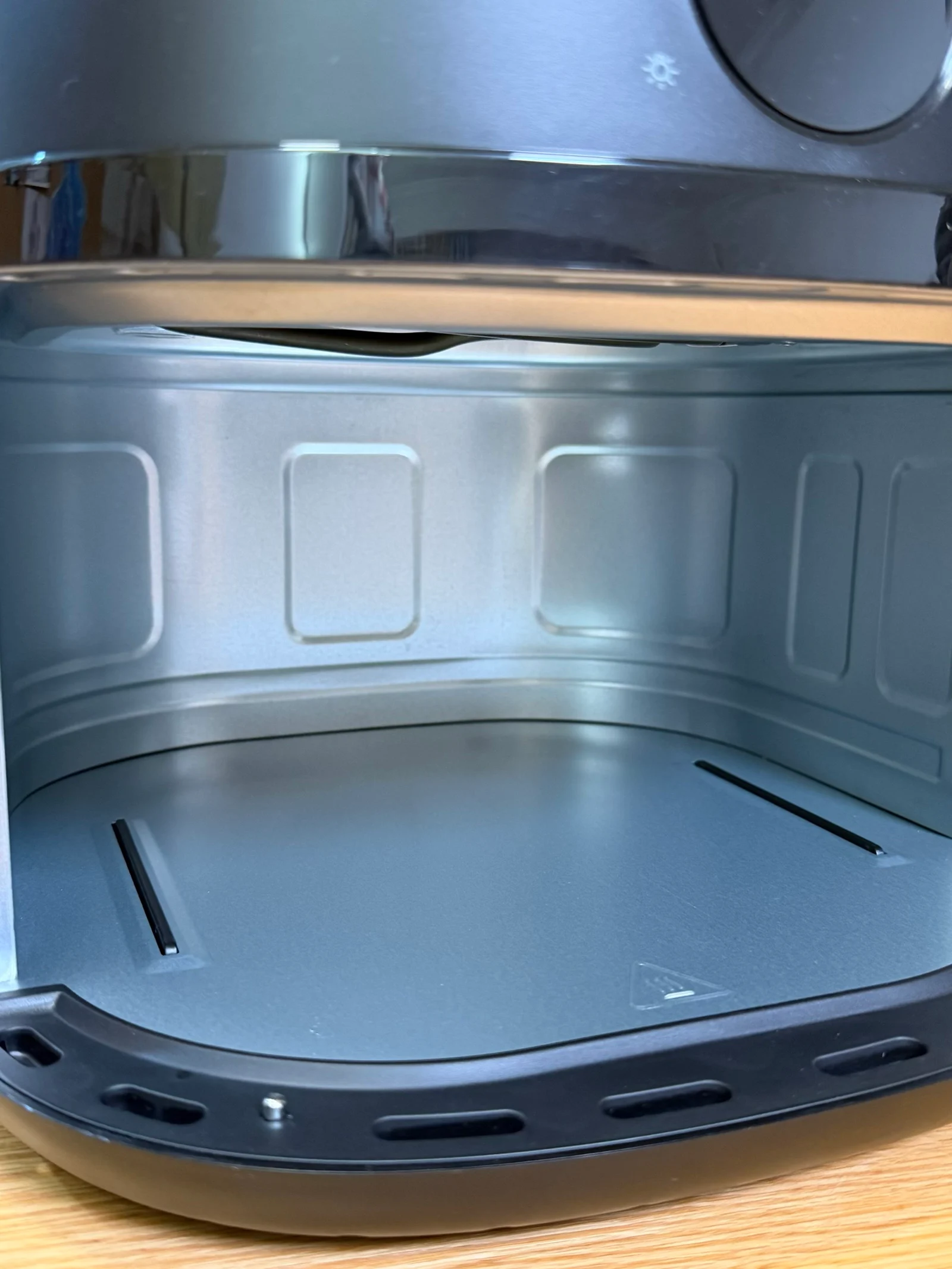 The air fryer’s interior with the basket removed.