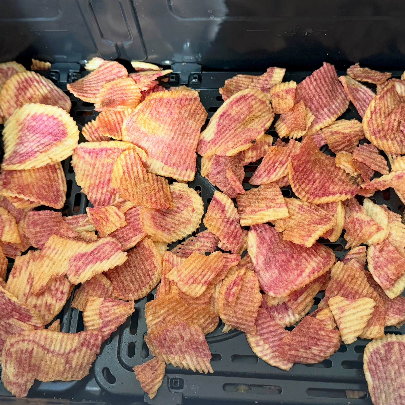 Ridged crisps spread across the basket insert.