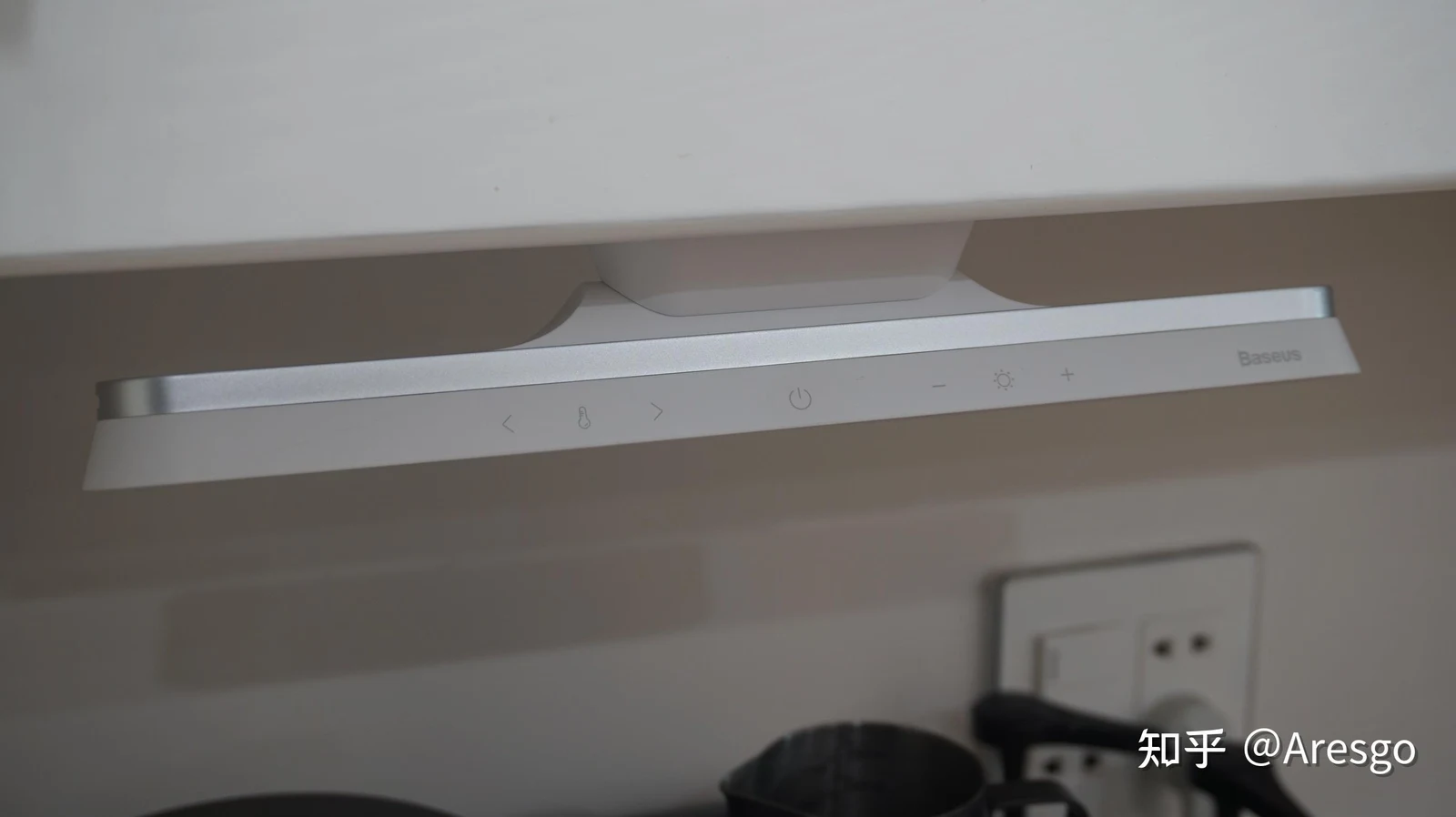 Baseus magnetic rechargeable LED light bar mounted underneath a white cabinet with touch controls for color temperature, power, and brightness.