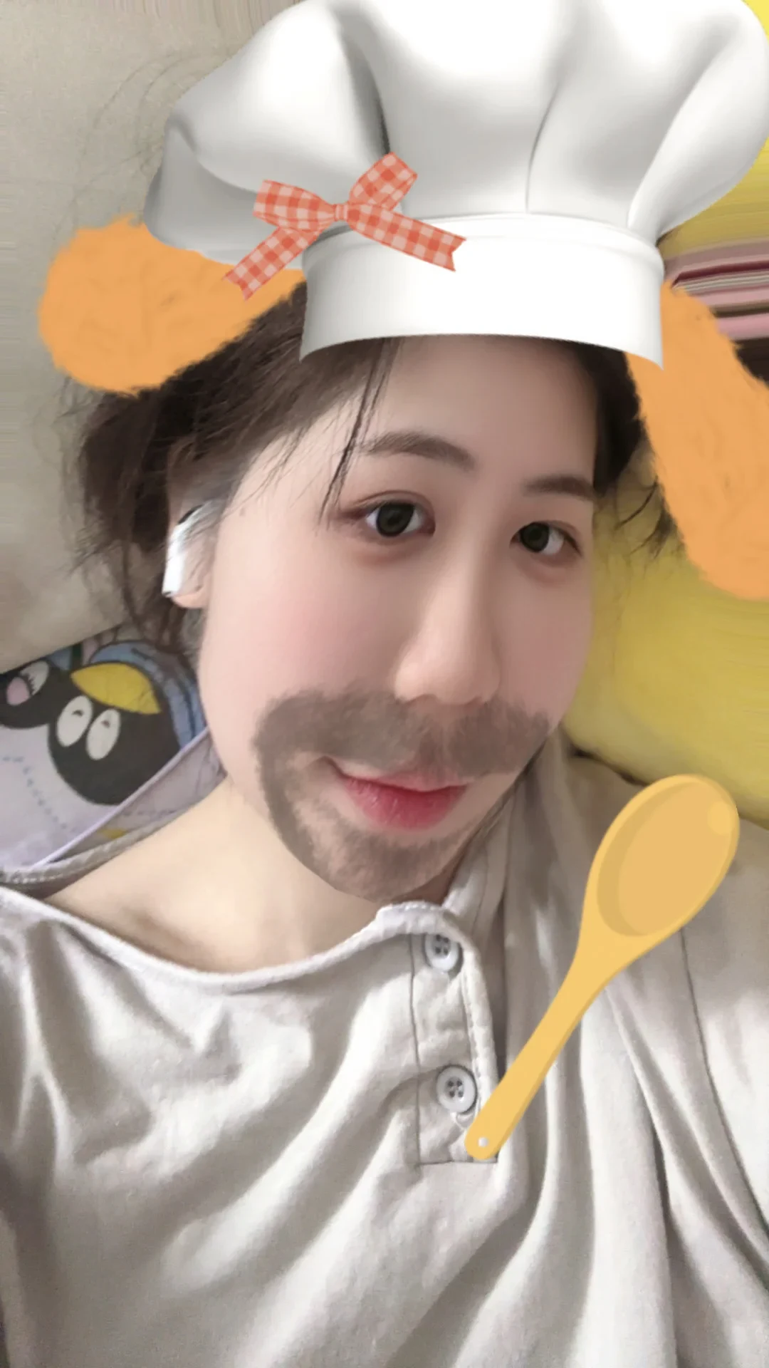 A filtered selfie from the source post showing a white stem-style earbud, with a chef-hat and moustache effect.