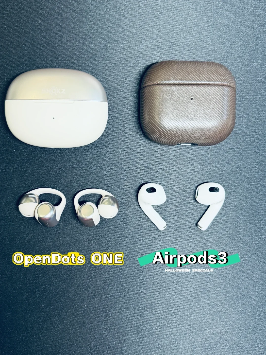 A comparison photo of two sets of wireless earphones against a dark gray background. On the left is the Shokz OpenDots ONE with its two-tone oval charging case and open-ear earbuds, labeled 'OpenDots ONE'. On the right is Apple AirPods 3 with its case in a textured brown protective cover and both earbuds displayed beneath, labeled 'Airpods3'.