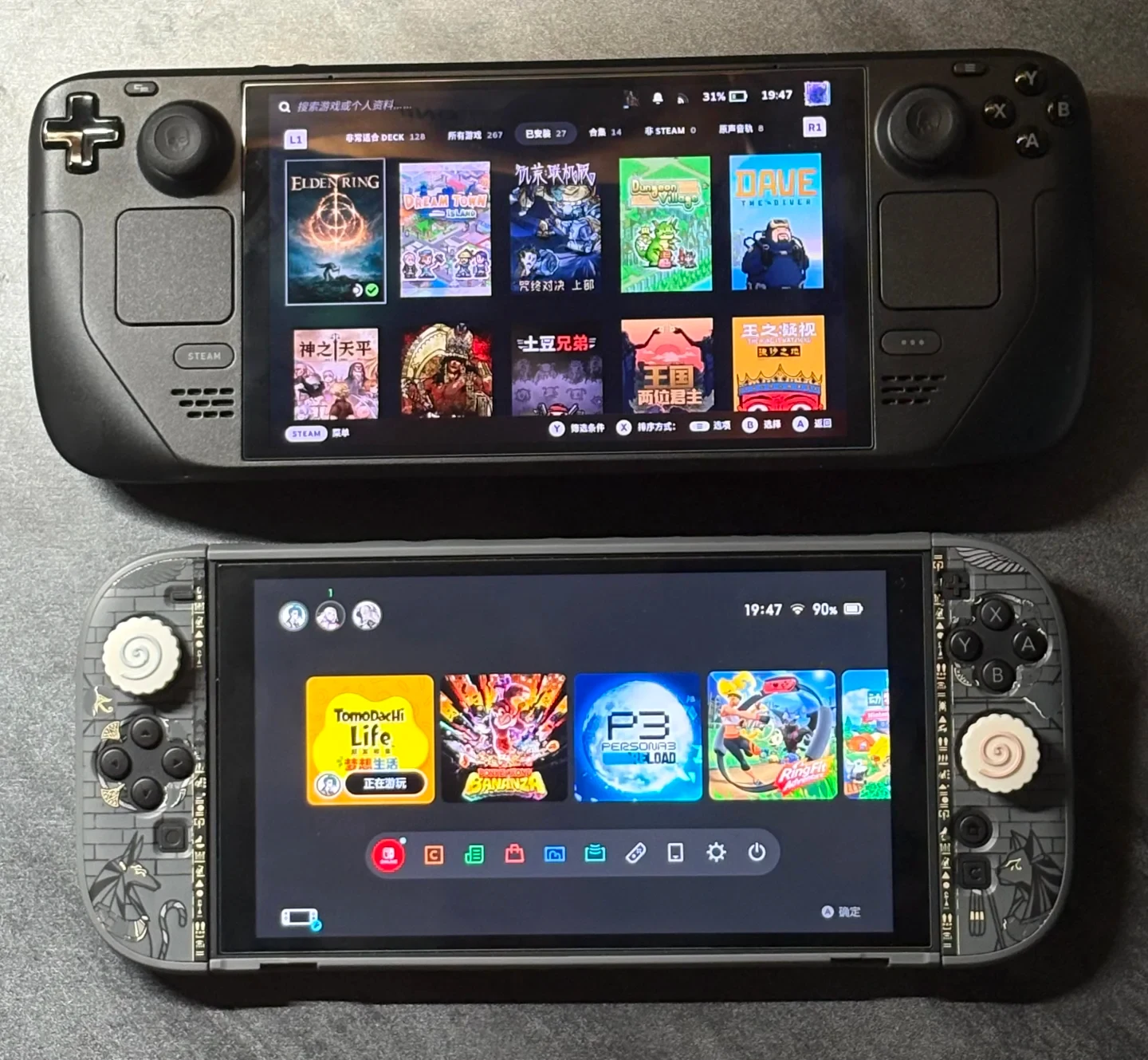A black Steam Deck handheld console positioned above a Nintendo Switch with custom Egyptian-themed Joy-Con controllers, both powered on and displaying their respective game library screens.