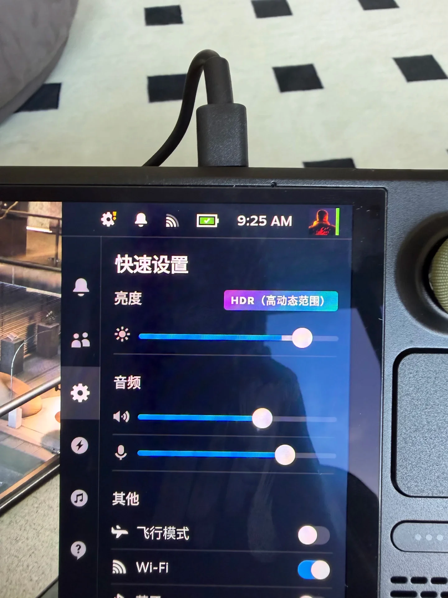 Close-up of a Steam Deck handheld console plugged in, displaying its Quick Settings side menu on screen.