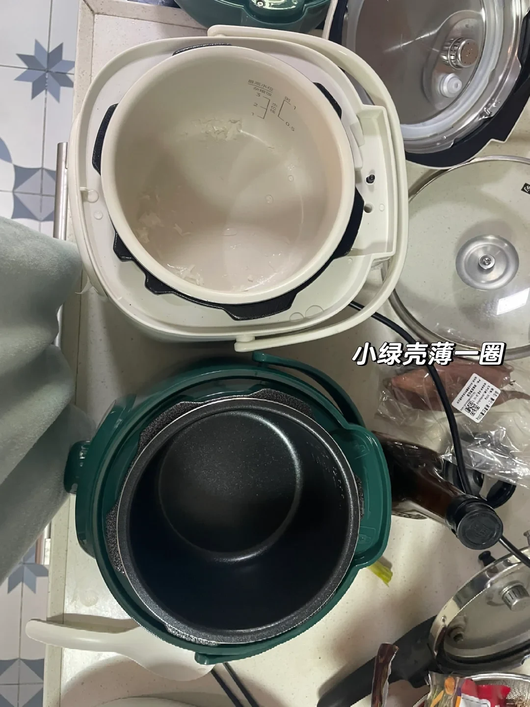 Top-down view of the open white and green mini electric pressure cookers, showing their light and dark inner pots
