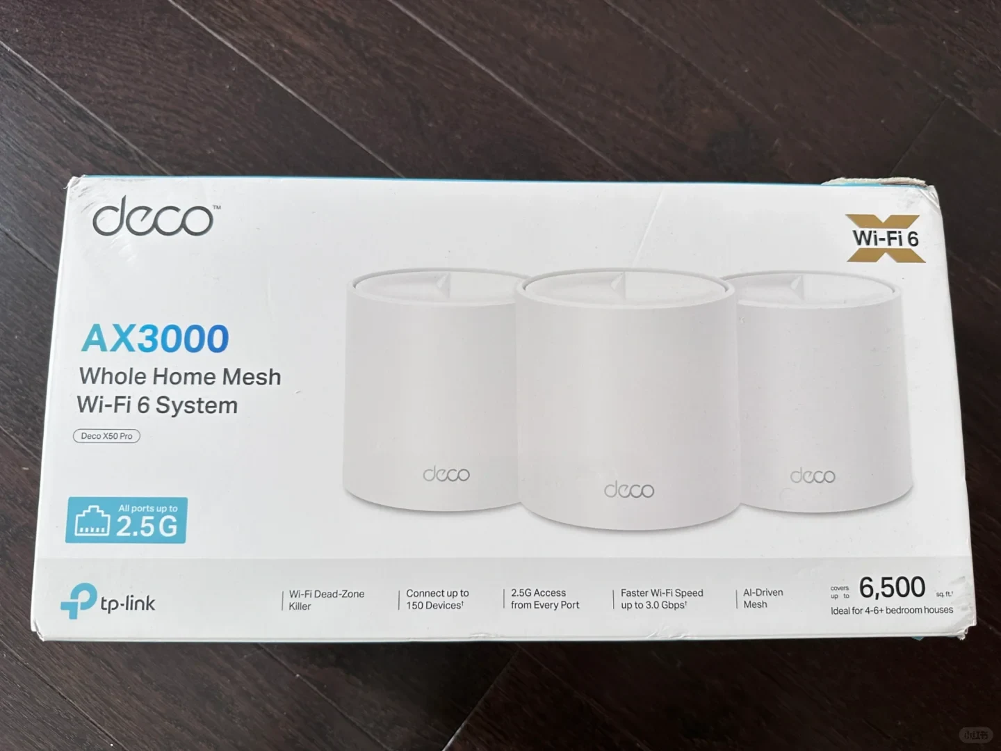 A product packaging box for the TP-Link Deco X50 Pro AX3000 Whole Home Mesh Wi-Fi 6 System, displaying images of three white cylindrical mesh router units along with key specifications such as 2.5G ports and coverage up to 6,500 square feet.