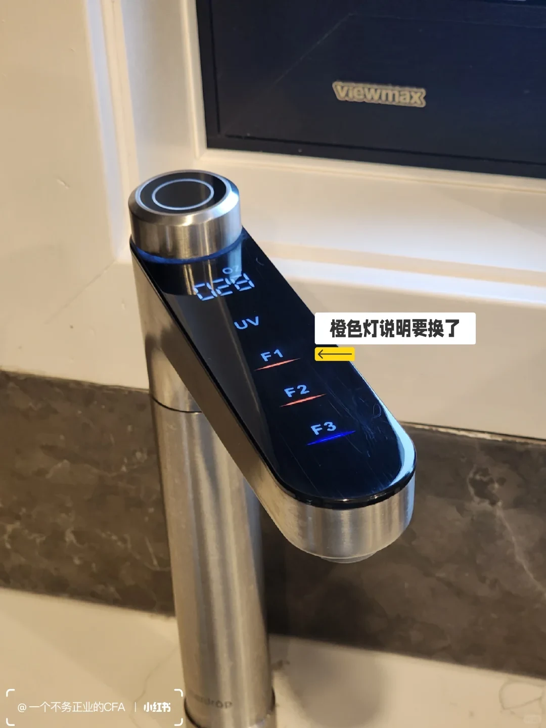 The X12 smart faucet displays its UV and filter indicators. F1 and F2 are orange while F3 is blue; the owner’s Chinese note points to an orange indicator as a replacement reminder.